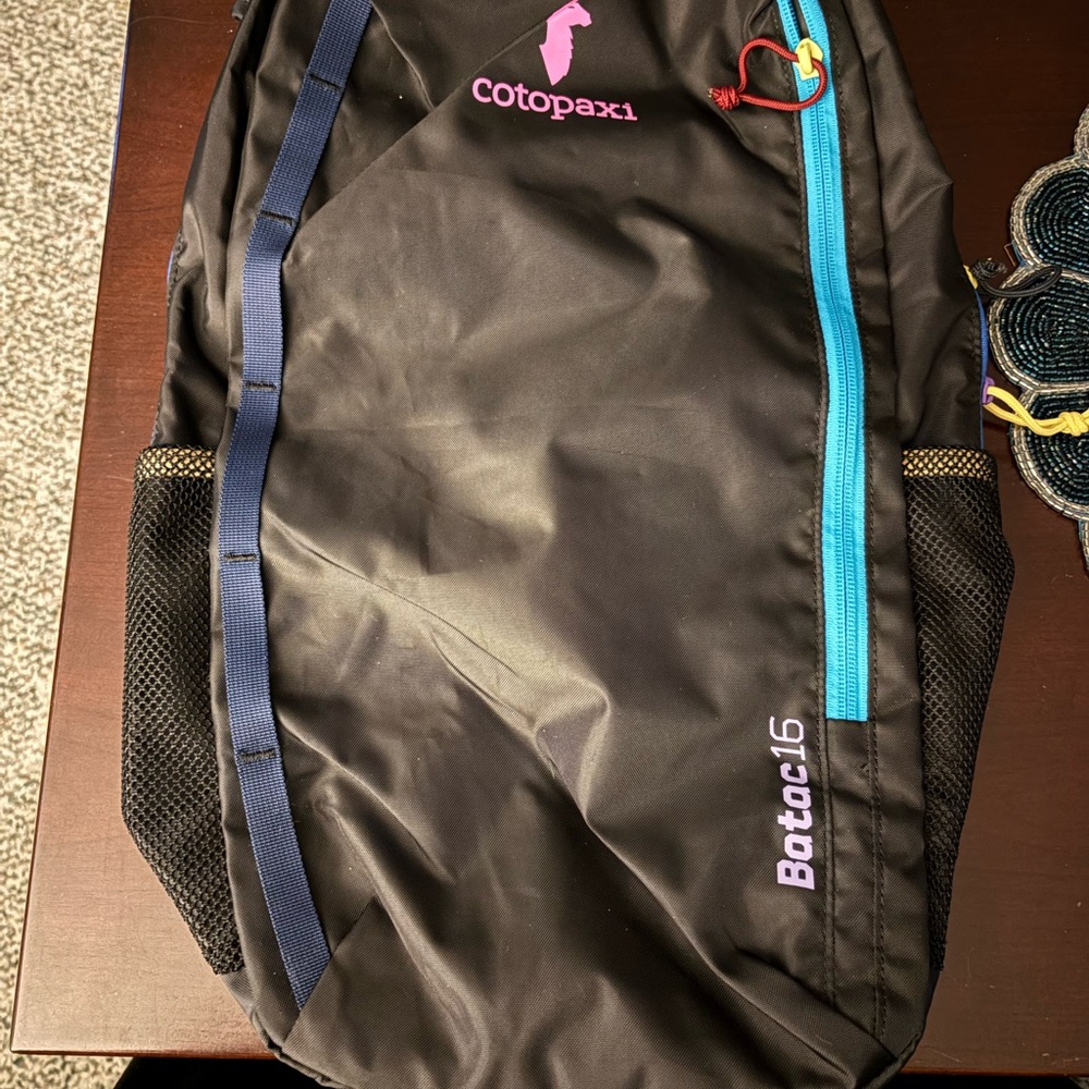 cotopaxi Black Backpack with Blue and Pink Accents